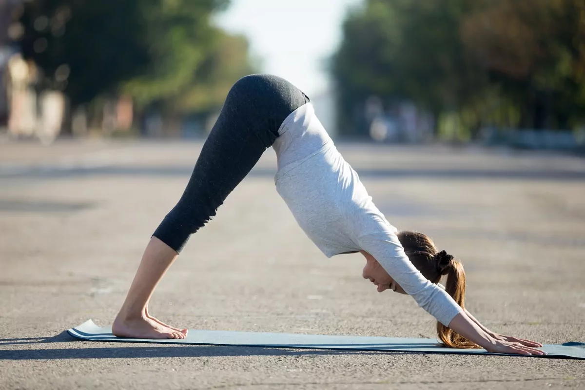 Downward Facing Dog with Knee-Pulls 10 Powerful Yoga Poses to Get a Flat Stomach